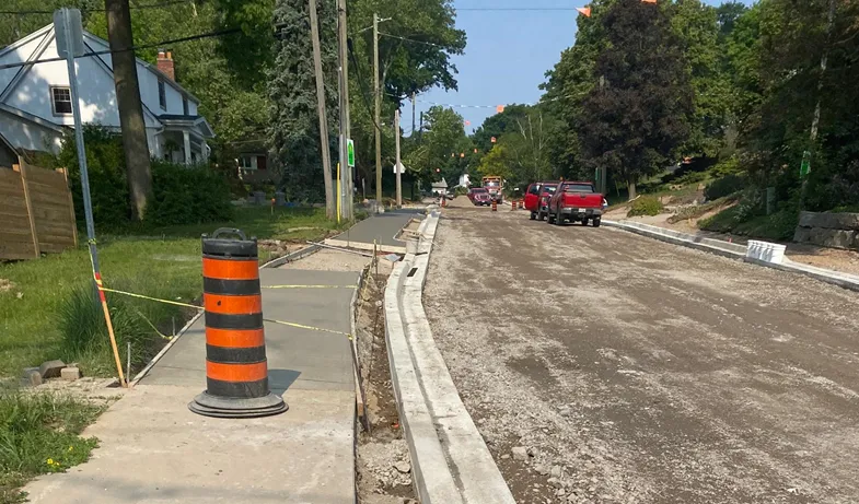 Roseview Ave and Gladstone Ave (Construction) - Active construction site with unpaved road, new concrete sidewalks, and curbs